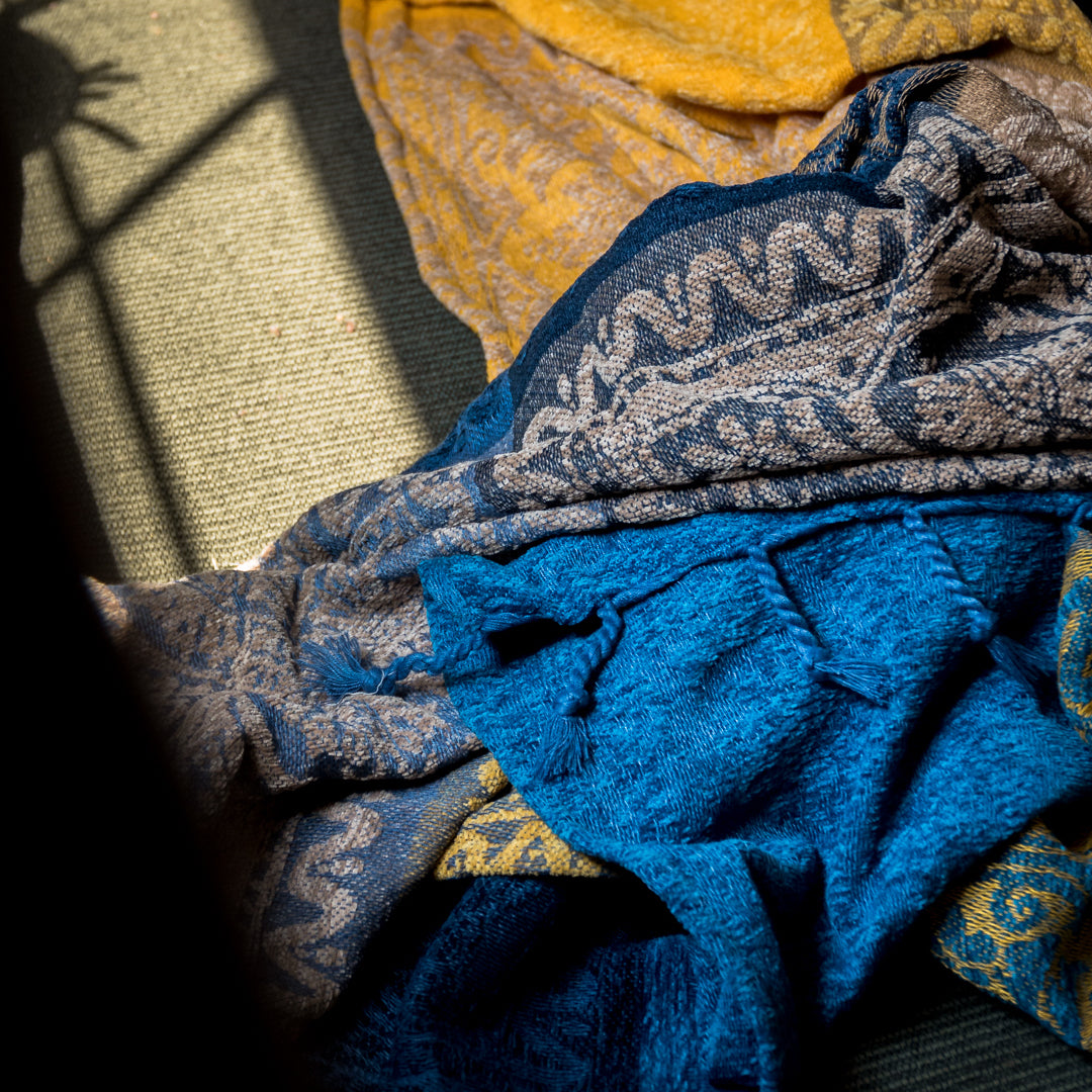 The Agra Blankets by Ecletticos. Blue and Gold with geometric patterns.